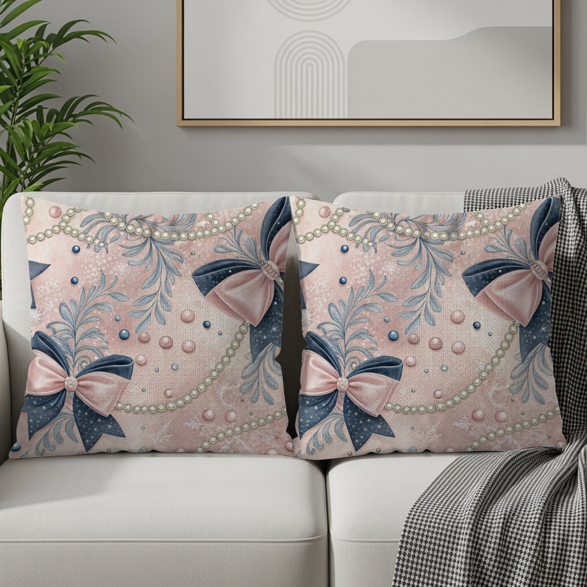 Pink and blue bow decorative pillow pair shown on an armchair with plant accent