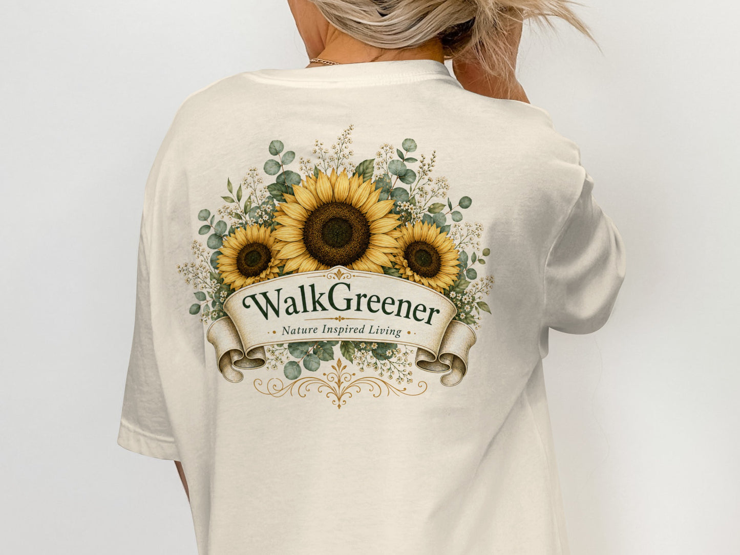 Cream t-shirt with a sunflower and foliage graphic reading "WalkGreener Nature Inspired Living."