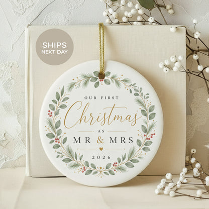 Round ornament with "Our First Christmas As Mr & Mrs 2026" text and floral design.