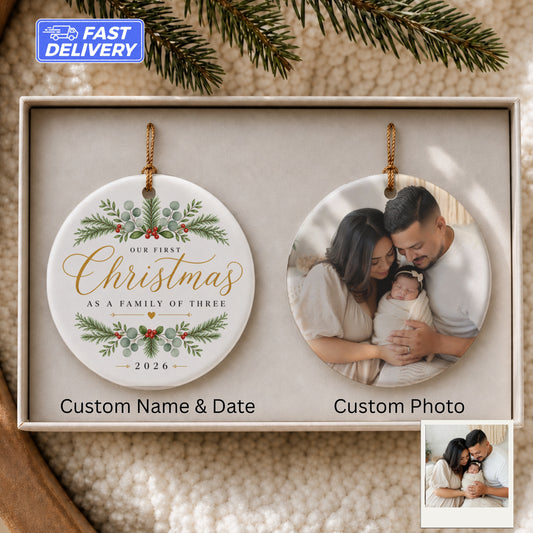 Round Christmas ornament with "Our First Christmas" and family photo.