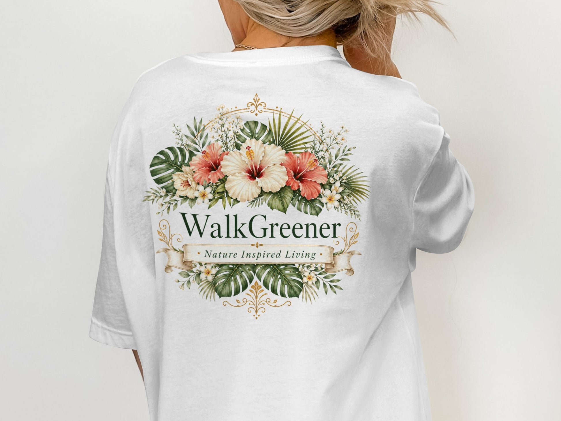 White t-shirt with floral design and text "WalkGreener. Nature Inspired Living."