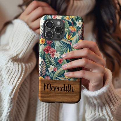 Personalized tropical flower phone case against a wood grain backdrop.
