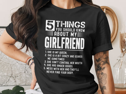 Black t-shirt with white text listing five things about a girlfriend.
