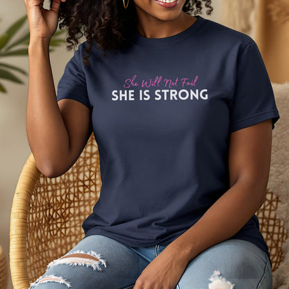Navy t-shirt with pink text "She Will Not Fail" and white text "SHE IS STRONG".
