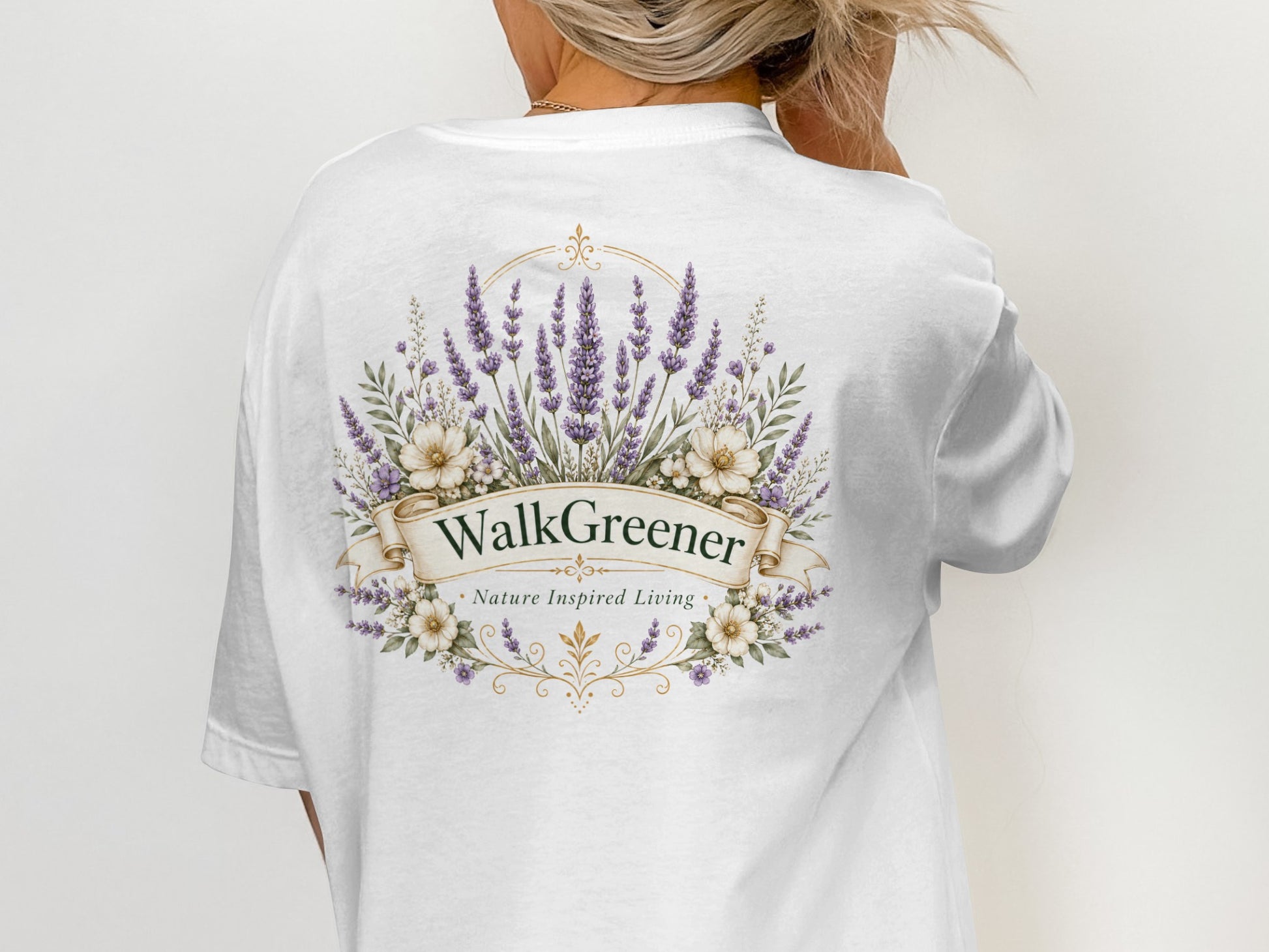 White t-shirt with "WalkGreener Nature Inspired Living" logo and floral wreath.