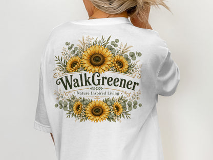 White t-shirt with sunflowers and the text "WalkGreener. Nature Inspired Living."
