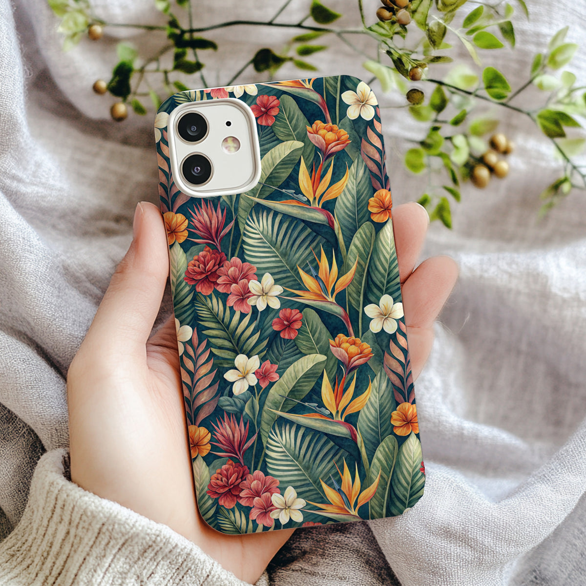 Close-up of the orange bird of paradise and hibiscus flower print on the phone case.
