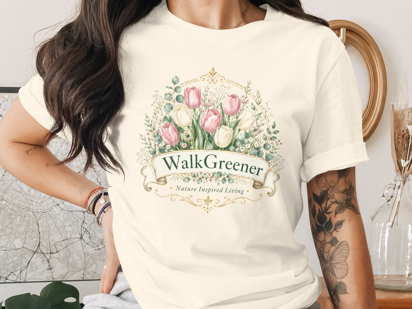 Cream t-shirt with a floral wreath, pink and white tulips, and the text "Walk Greener Nature Inspired Living."