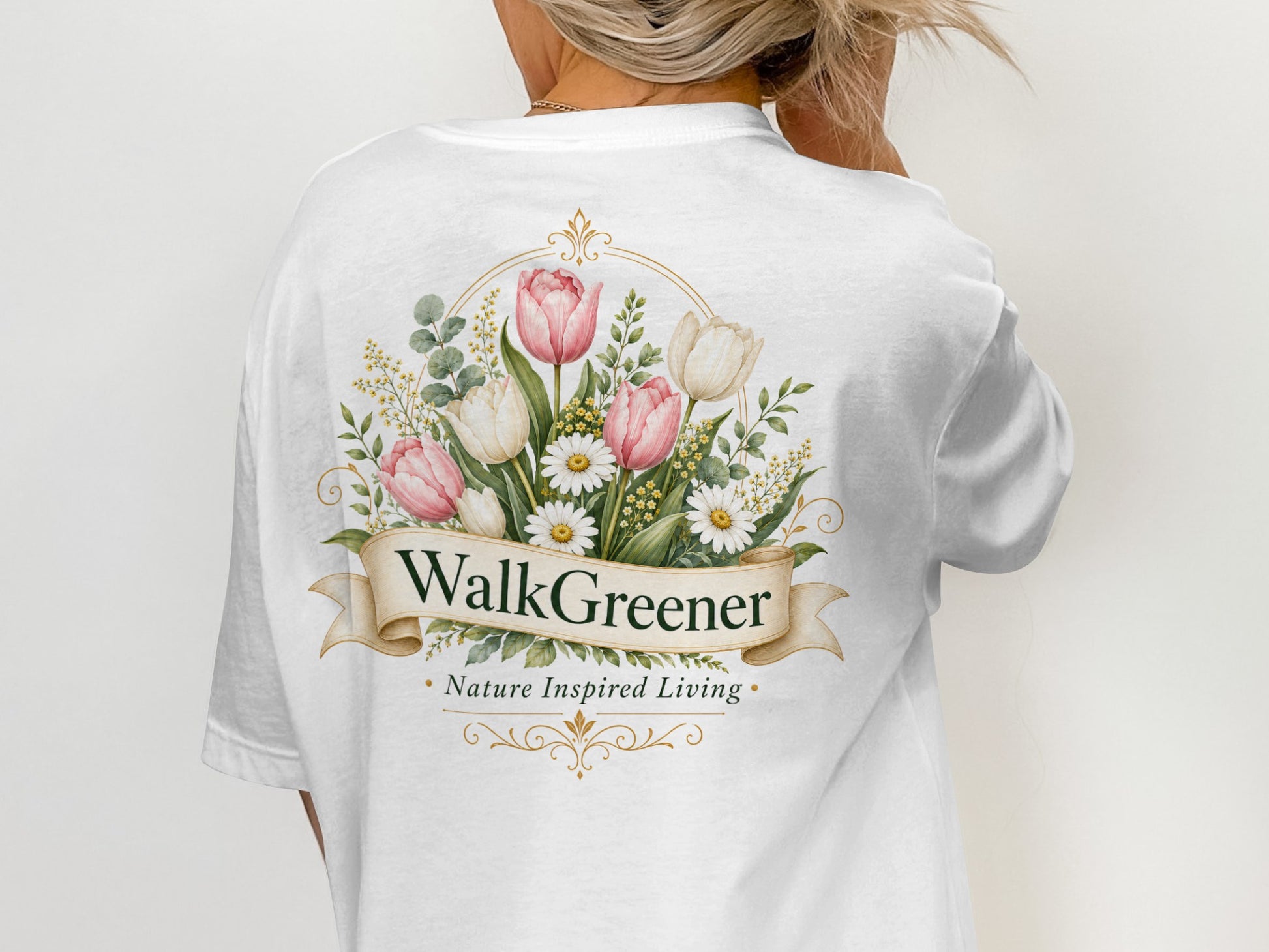 White t-shirt with "WalkGreener Nature Inspired Living" text and floral design.