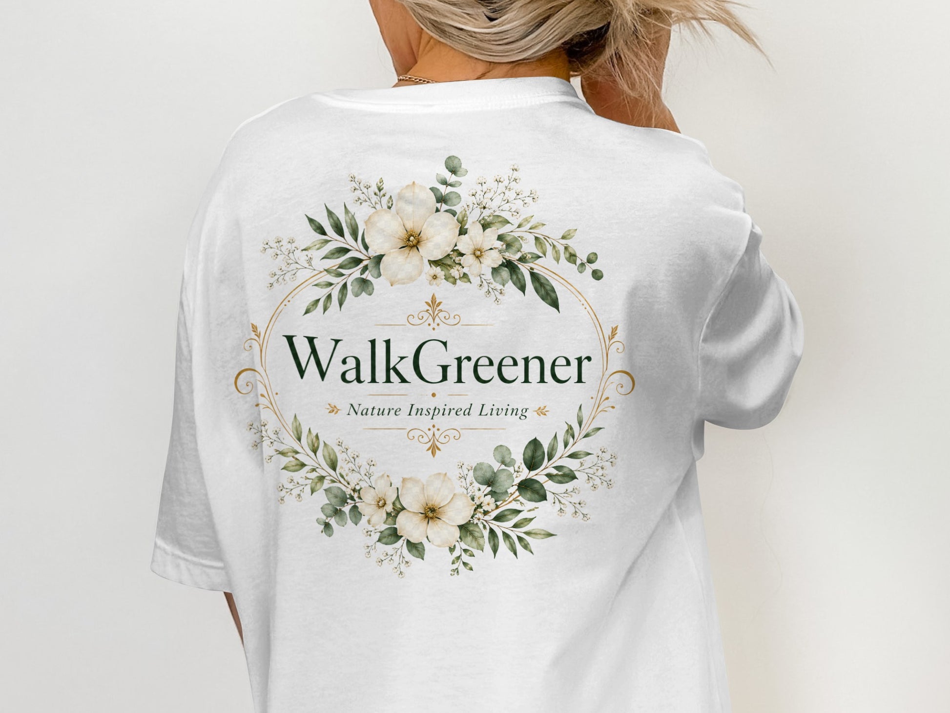 White t-shirt with "WalkGreener Nature Inspired Living" logo surrounded by floral wreath.