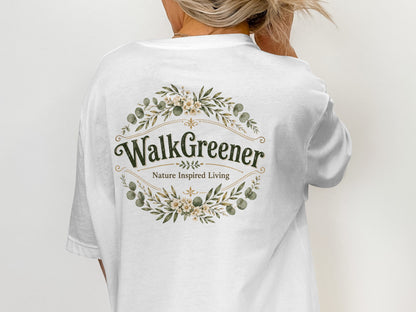White t-shirt with "Walk Greener Nature Inspired Living" logo with floral wreath.