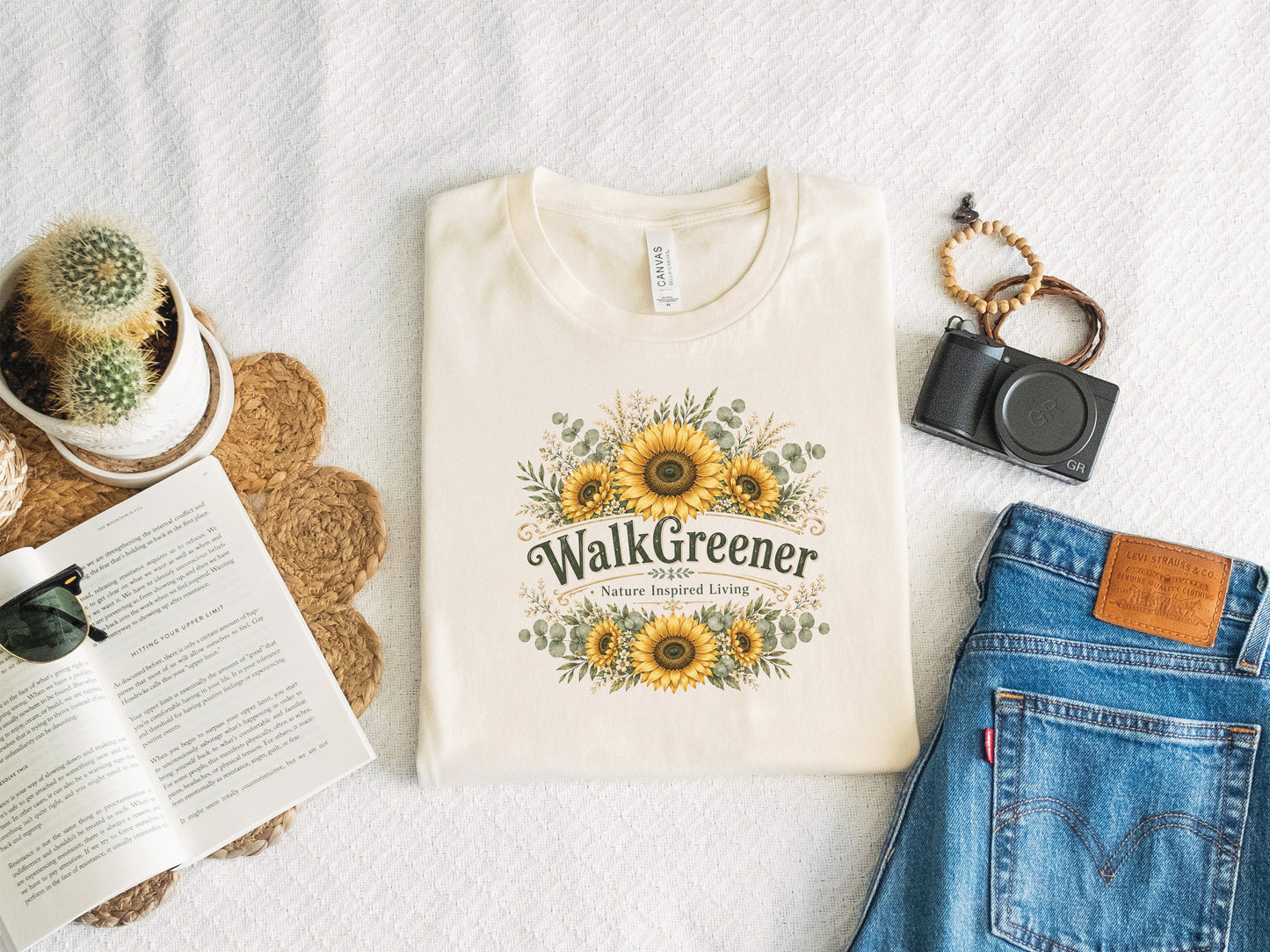 Cream t-shirt with "Walk Greener Nature Inspired Living" and sunflower graphic.