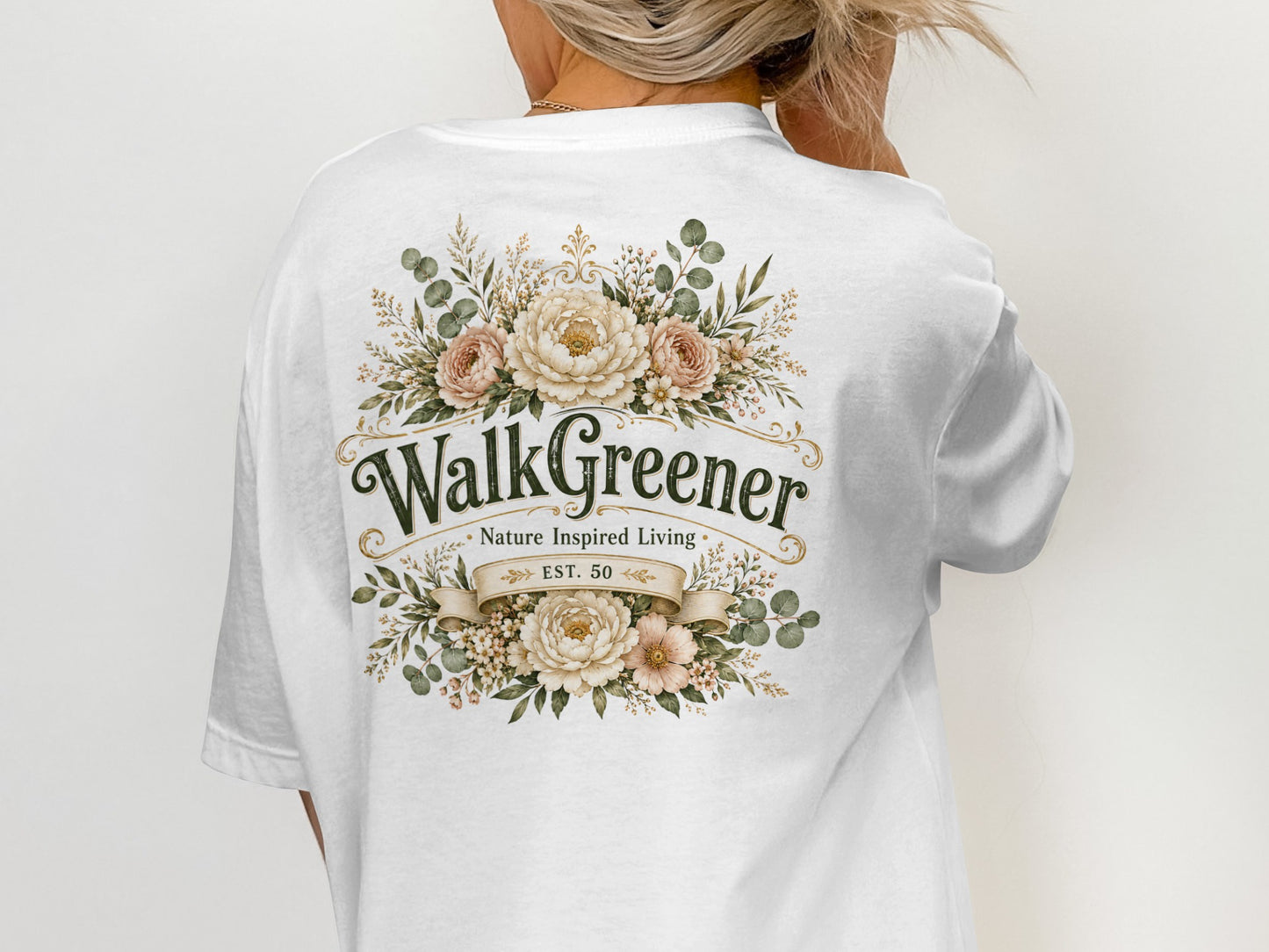 White t-shirt with floral design and text "WalkGreener Nature Inspired Living EST. 50".