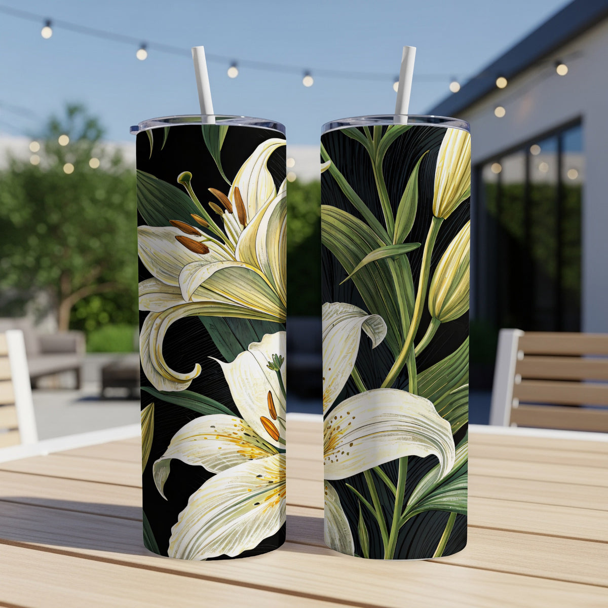Black tumbler with white lily print shown with its reusable straw and lid