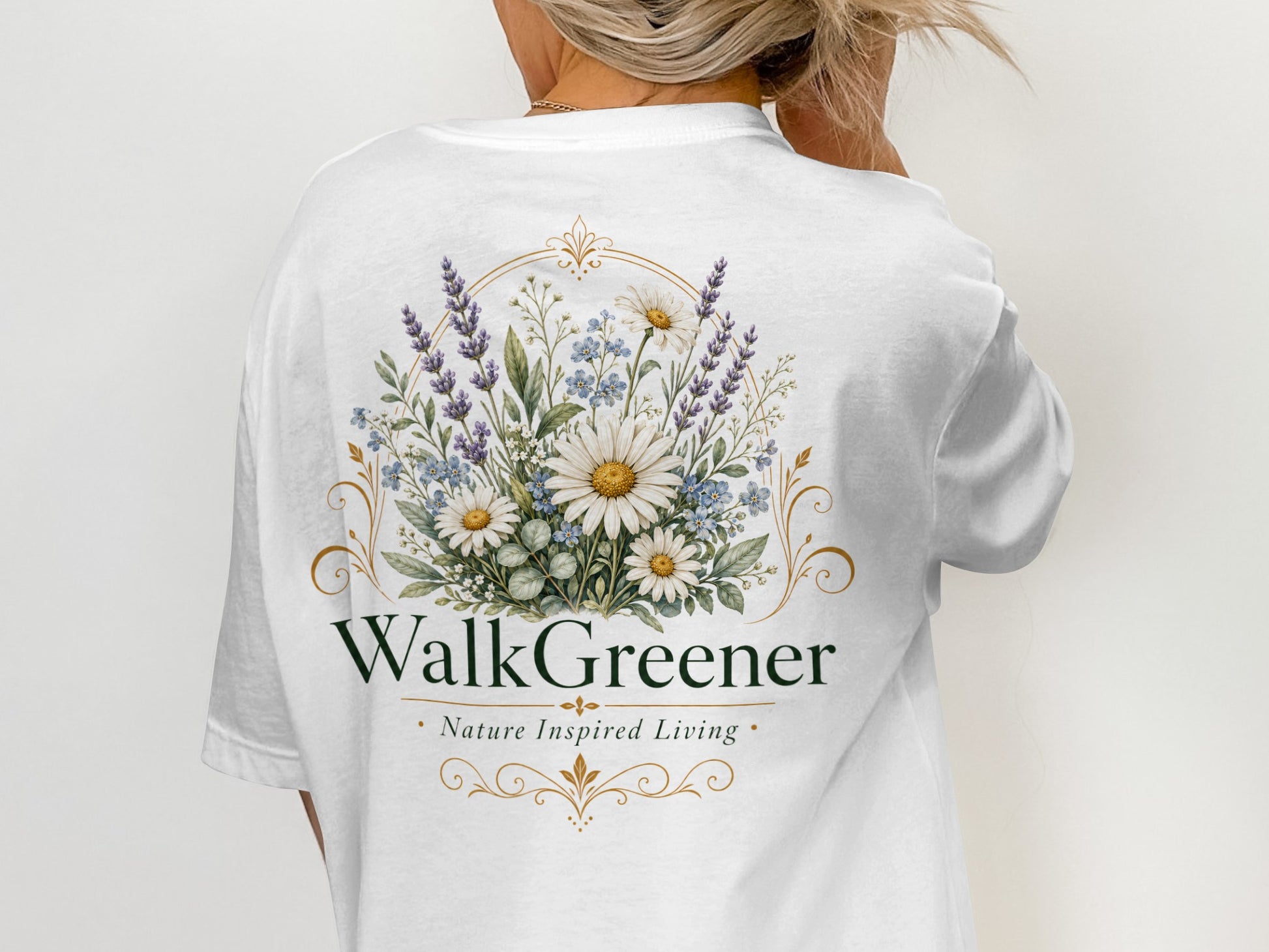 White t-shirt with floral design and text "WalkGreener Nature Inspired Living".
