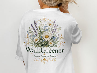White t-shirt with floral design and text "WalkGreener Nature Inspired Living".