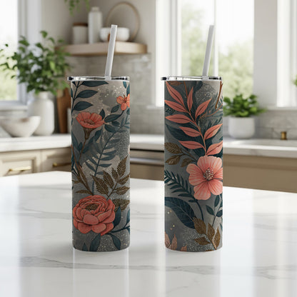 Tall skinny floral print tumbler with straw, showcasing the peach blooms and teal leaf pattern along the cup's silhouette.