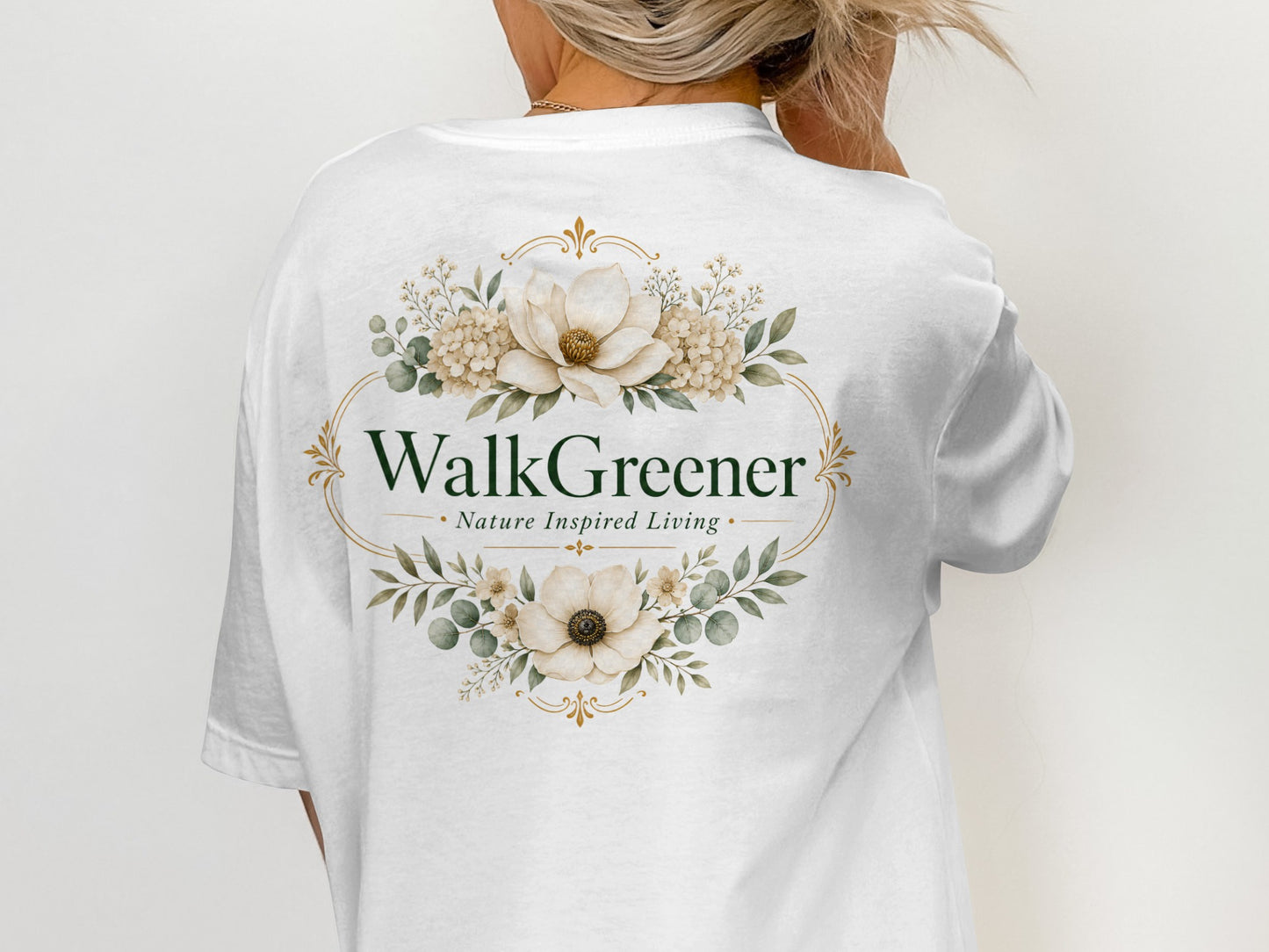 White t-shirt with oval floral design and text "WalkGreener Nature Inspired Living."