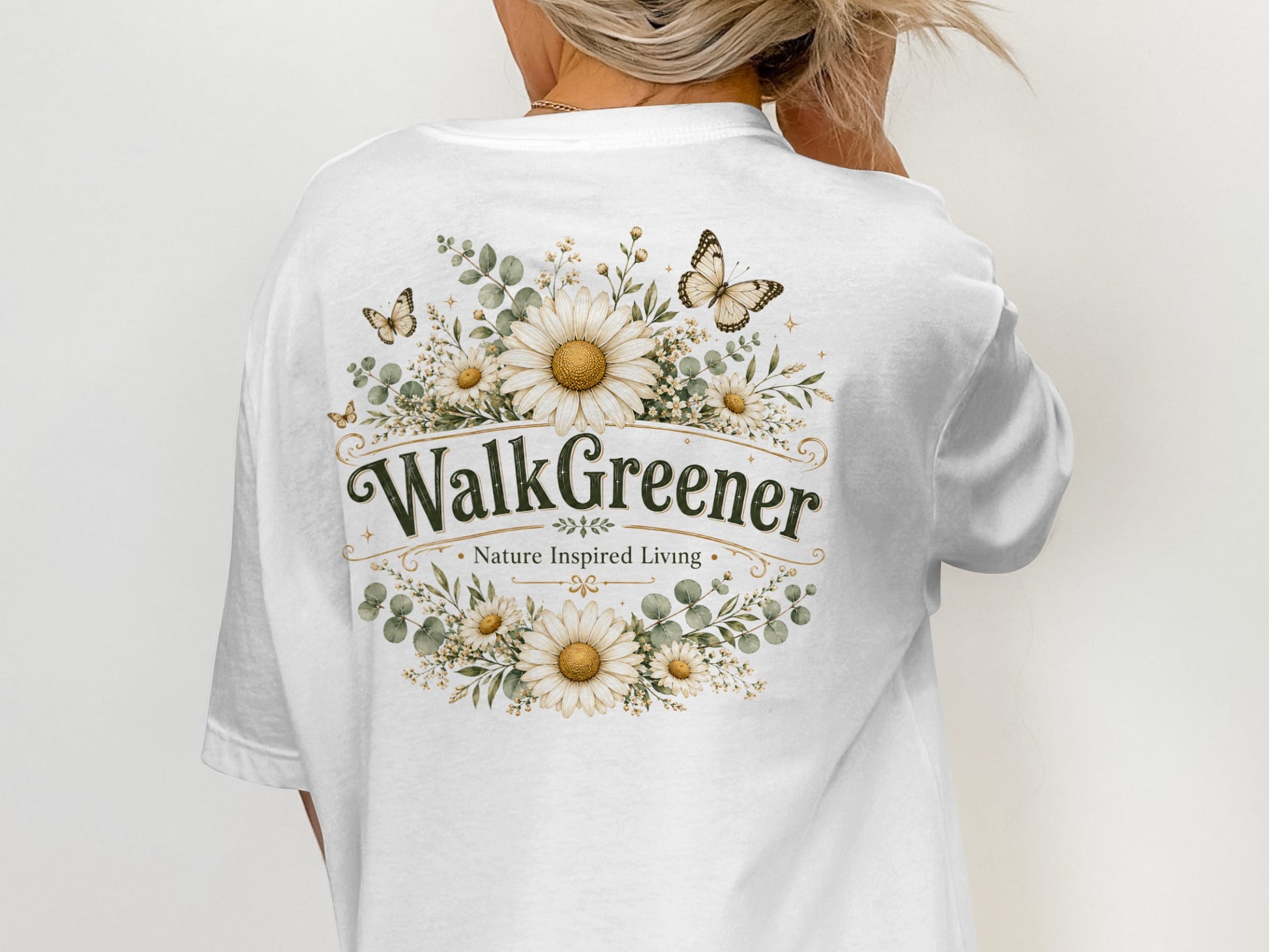 White t-shirt with "WalkGreener - Nature Inspired Living" design and floral accents.