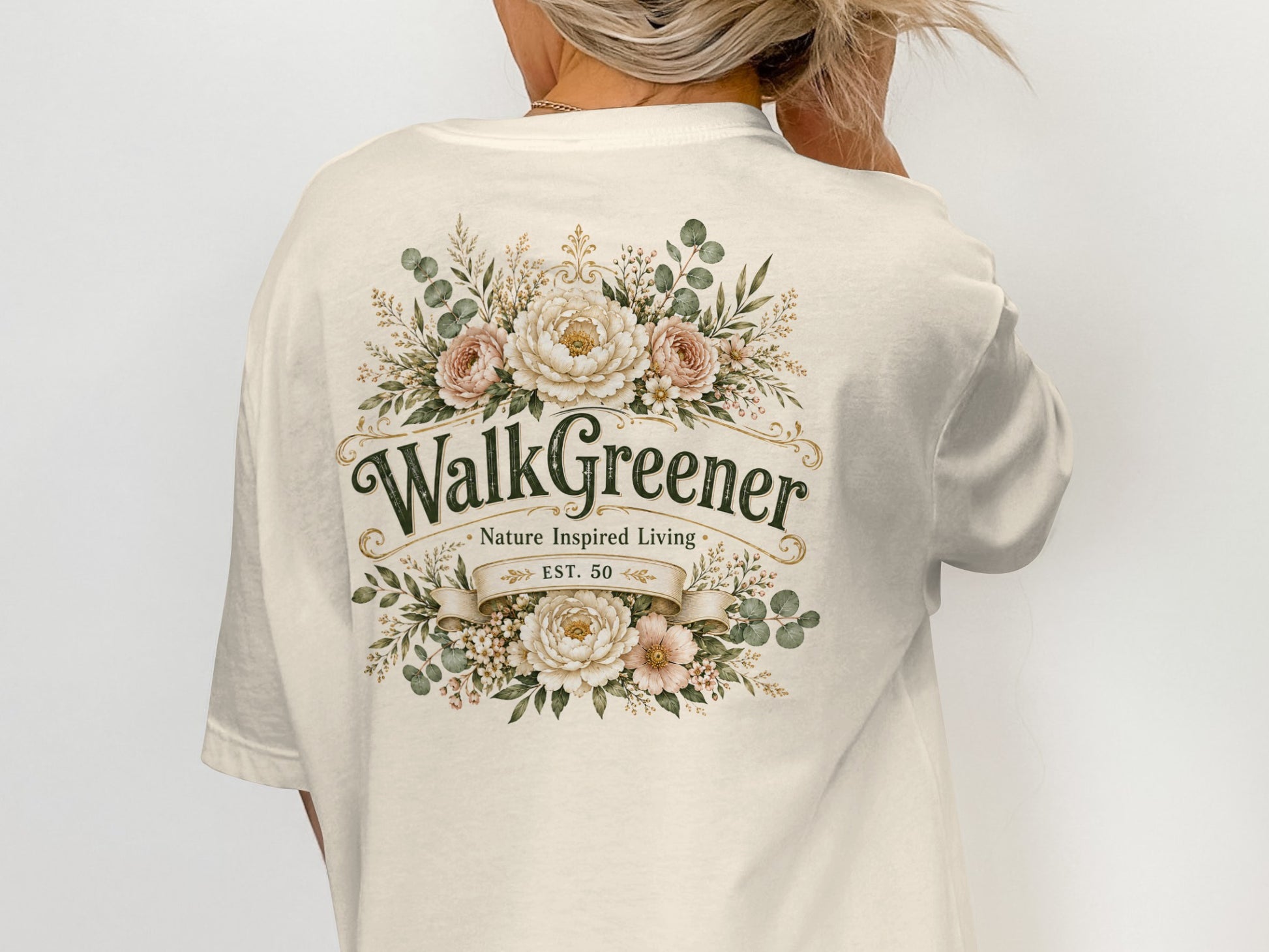 Cream t-shirt on back with "WalkGreener Nature Inspired Living Est. 50" and floral design.