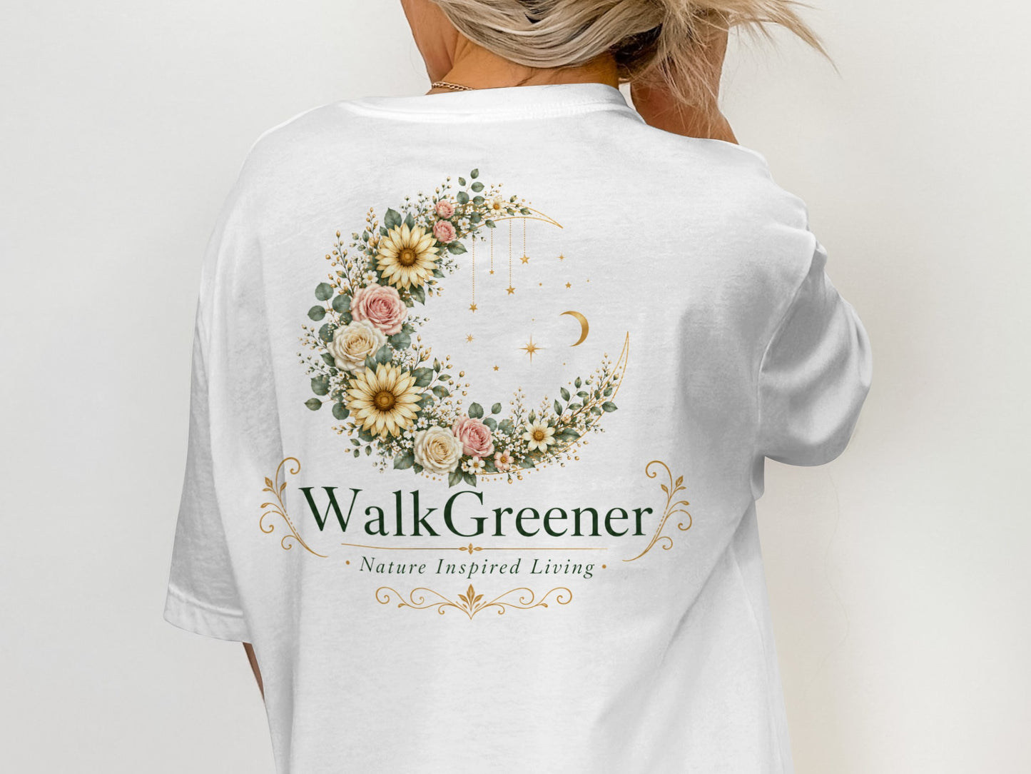White t-shirt with a crescent moon floral wreath and "WalkGreener Nature Inspired Living" text.