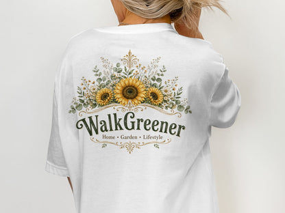 White t-shirt with a floral design featuring sunflowers and the text "WalkGreener Home Garden Lifestyle".
