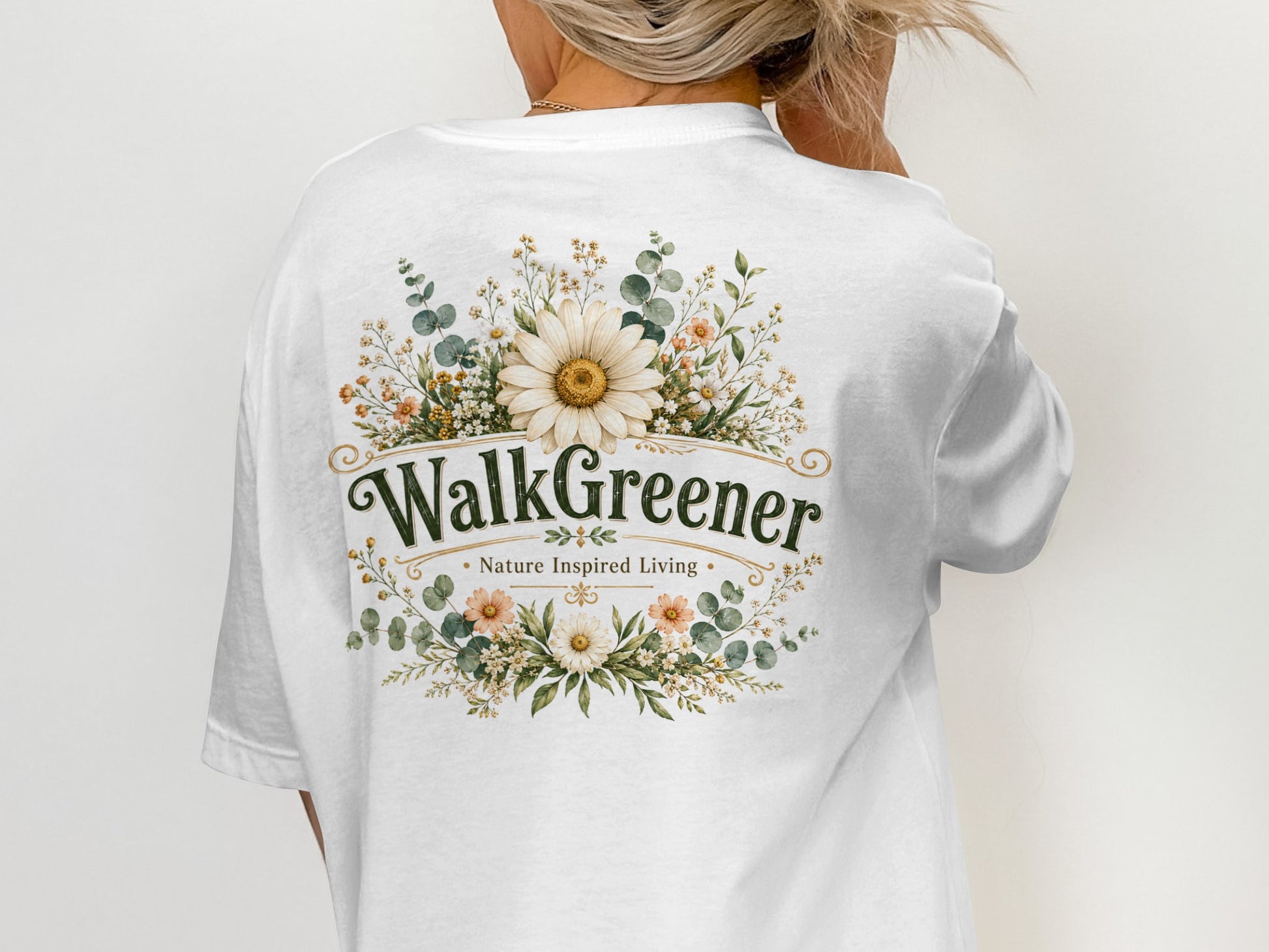 White t-shirt with a floral design and text "WalkGreener Nature Inspired Living".