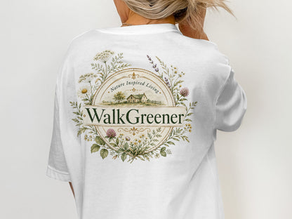 White t-shirt with a circular floral design and "WalkGreener Nature Inspired Living" text.