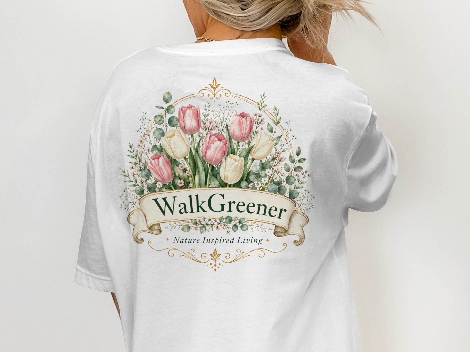 White t-shirt with floral design and text "WalkGreener Nature Inspired Living".