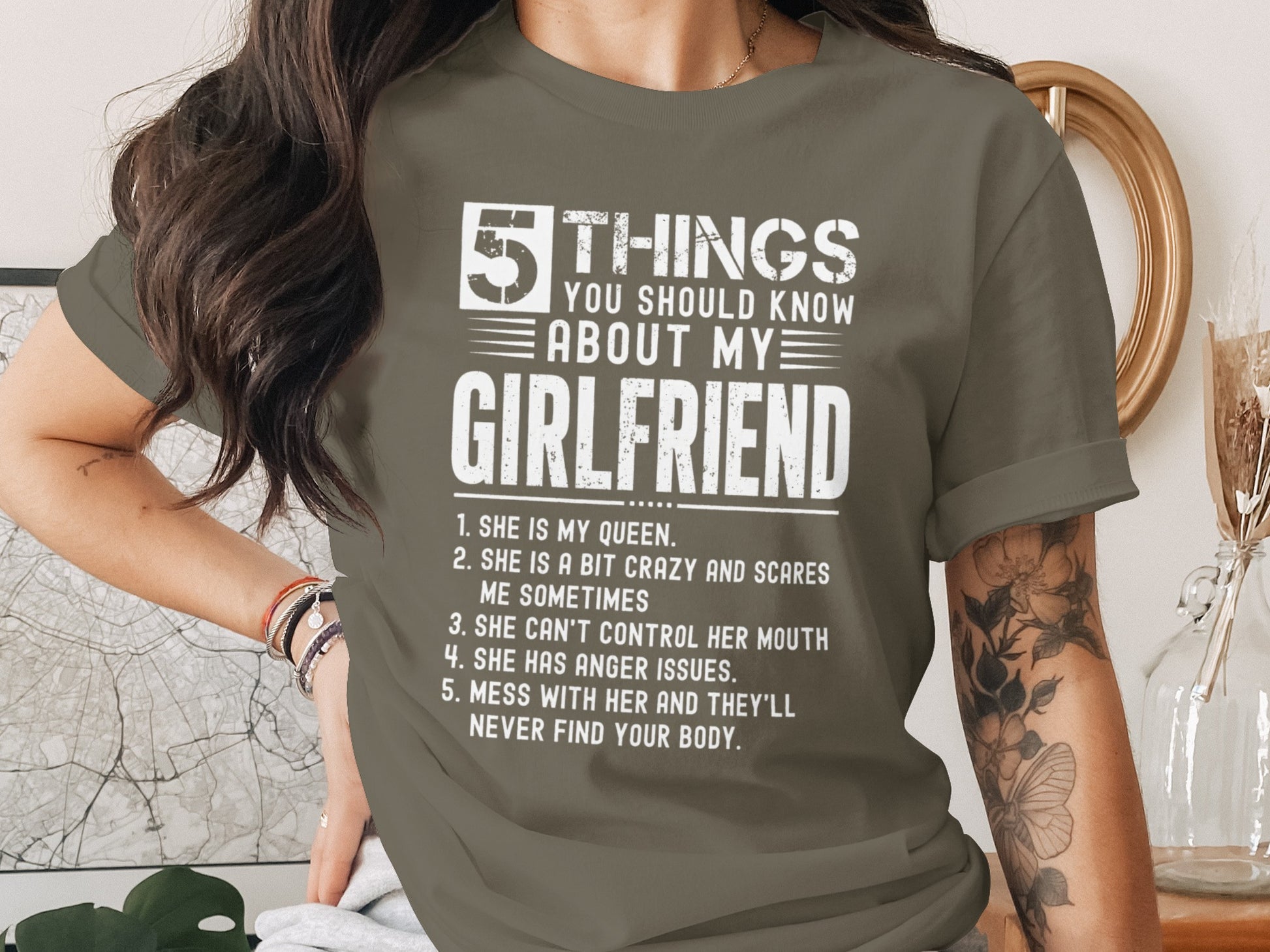 Green t-shirt with white text listing five things about a girlfriend.
