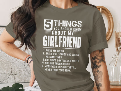 Green t-shirt with white text listing five things about a girlfriend.