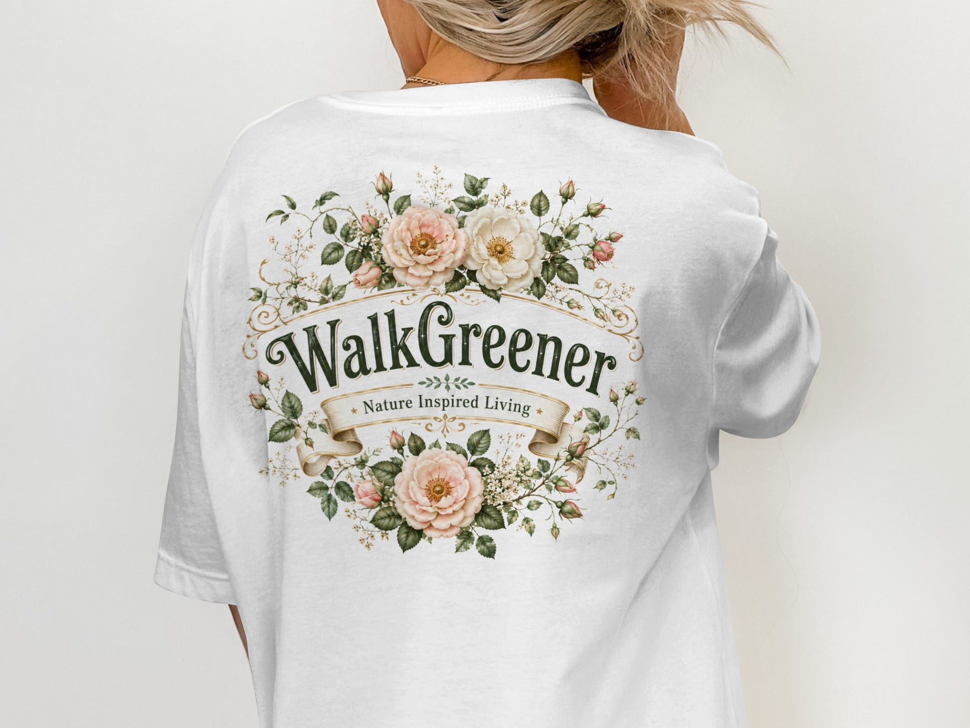 White t-shirt with "WalkGreener Nature Inspired Living" text and floral border.