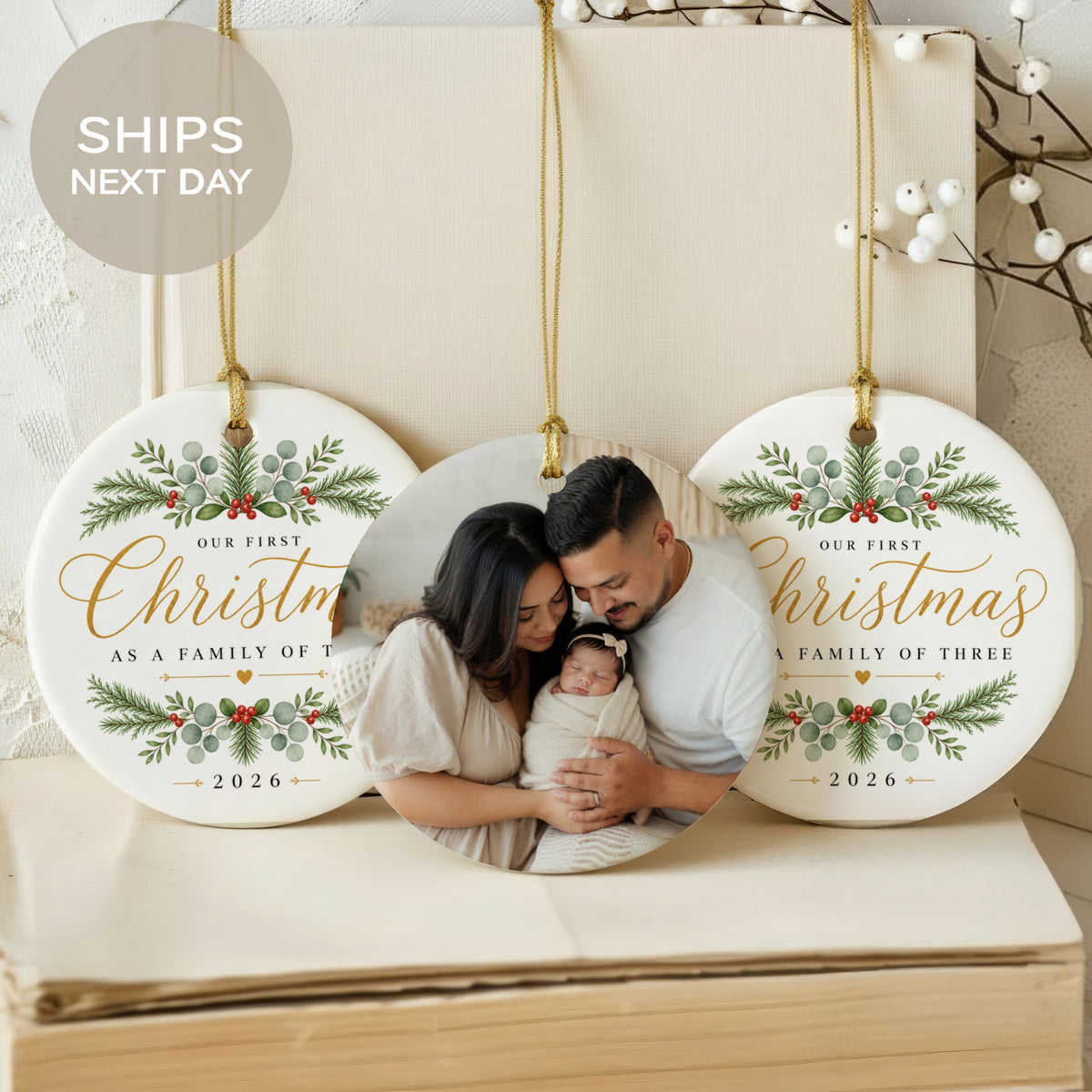 "Our First Christmas" ornament featuring a family photo and the year 2026.