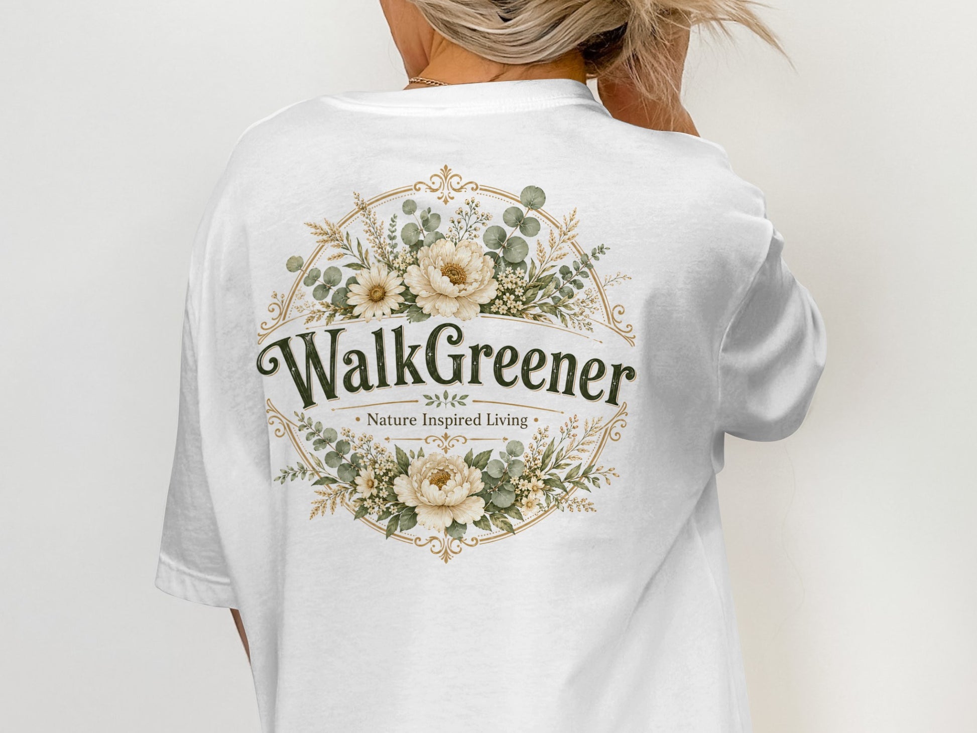 White t-shirt with "WalkGreener - Nature Inspired Living" text and floral emblem.