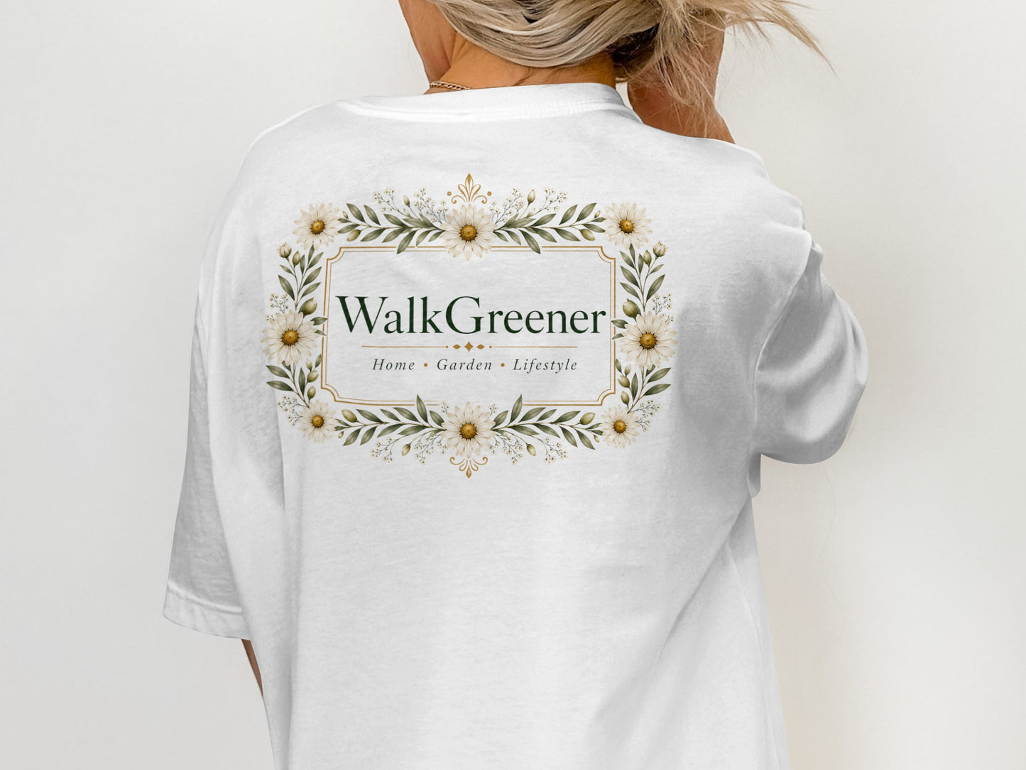 White t-shirt with "WalkGreener" logo framed by daisies and leaves.