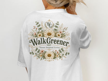 White t-shirt with "WalkGreener Nature Inspired Living" and floral wreath design.
