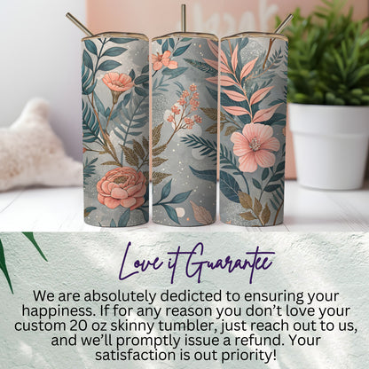 20oz skinny tumbler with straw showing the full 360-degree floral pattern design in peach, pink, and teal on a grey backdrop.