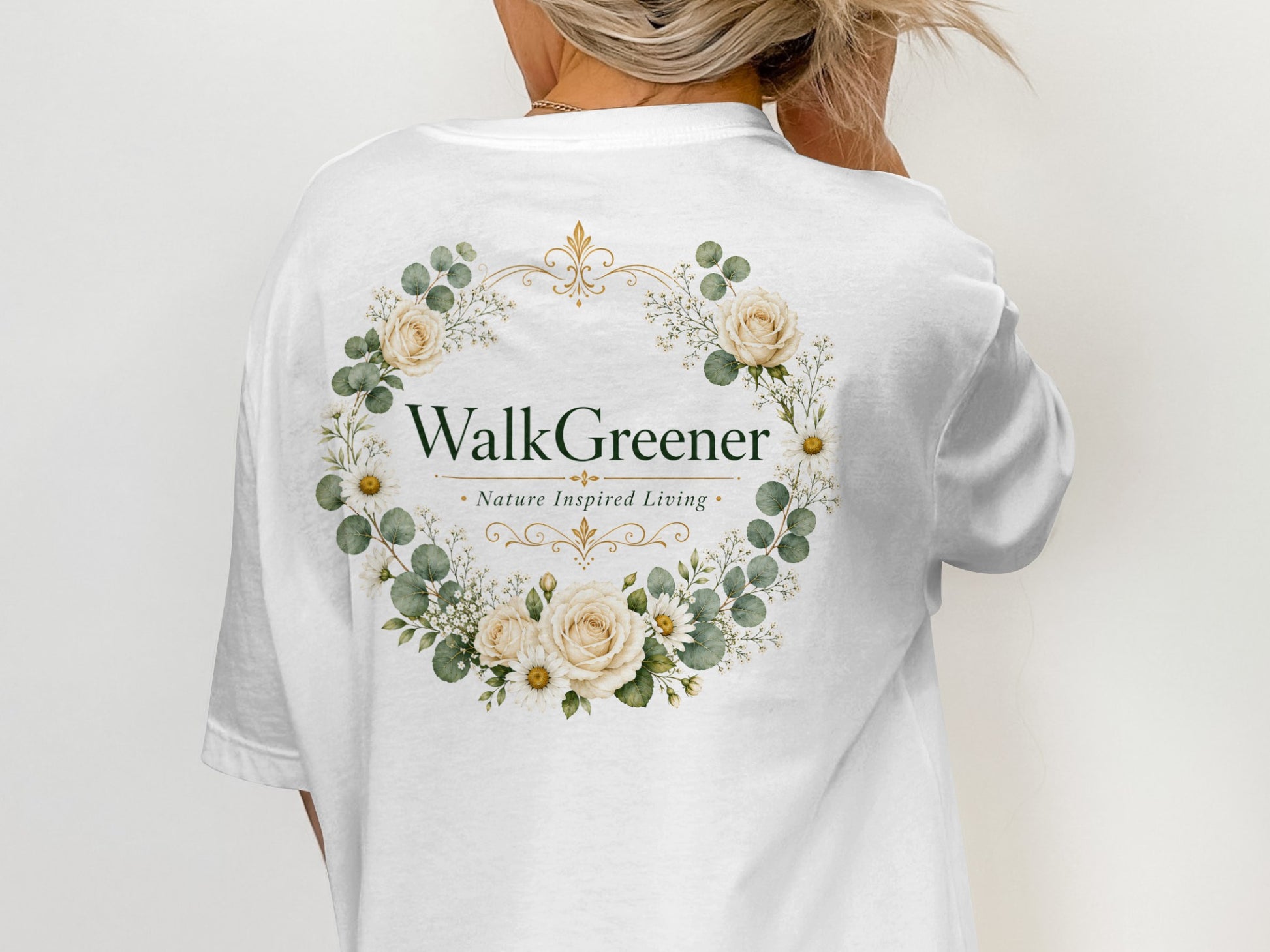 White t-shirt with "WalkGreener Nature Inspired Living" inside a floral wreath design.