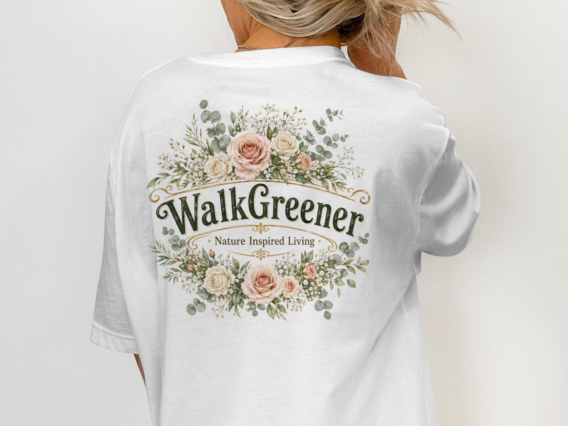 White t-shirt with "WalkGreener Nature Inspired Living" text and floral wreath design.