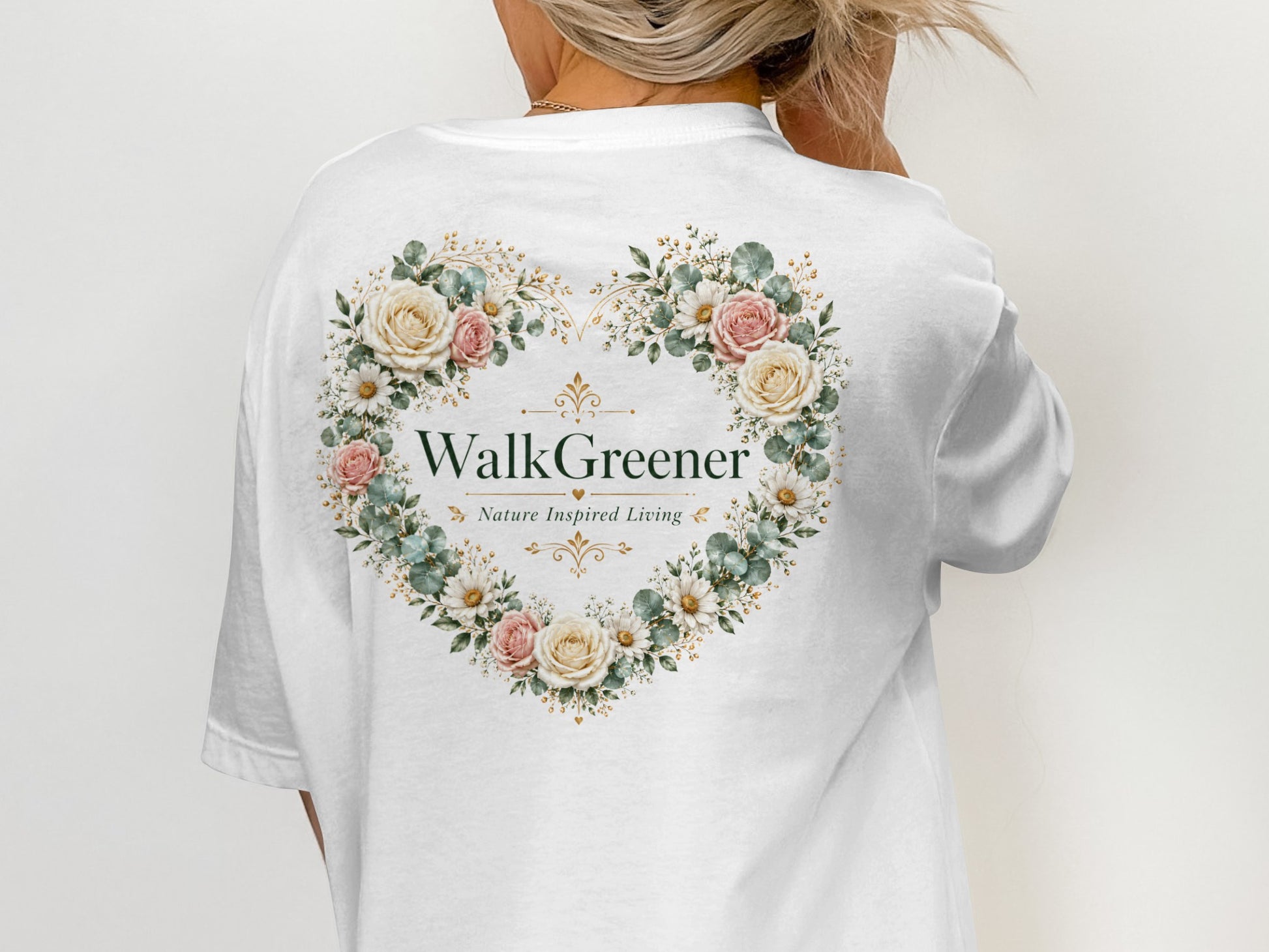 White t-shirt with a floral heart design and "WalkGreener Nature Inspired Living" text.