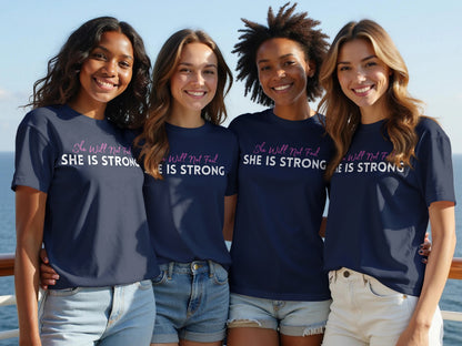 Four women wear navy t-shirts with the text "She Will Not Fail SHE IS STRONG".