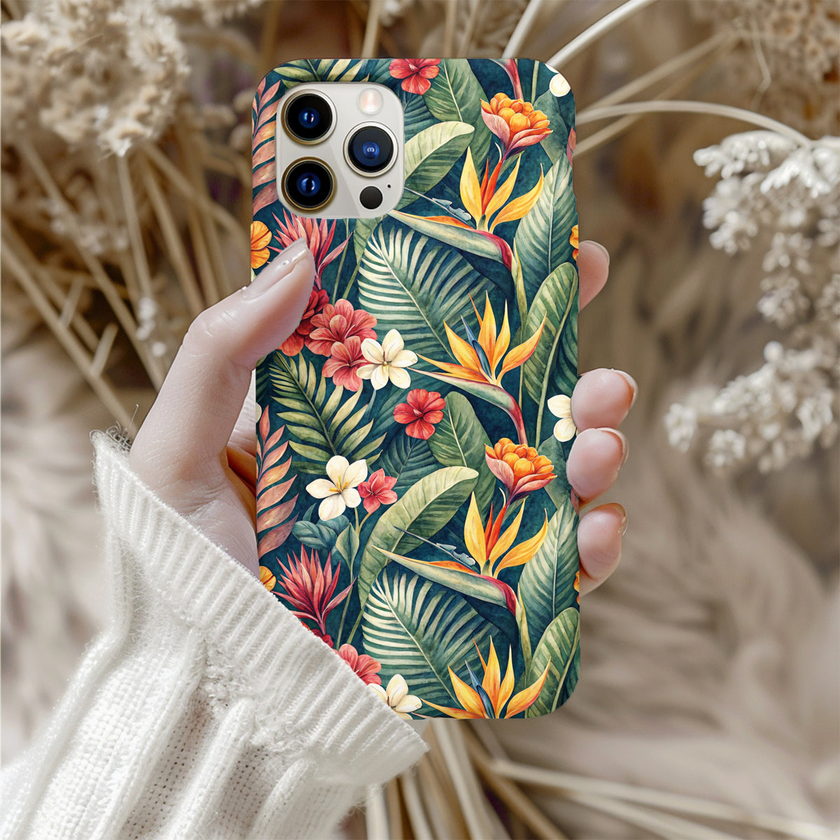 Tropical botanical phone case shown with camera cutout and green palm leaf detail.