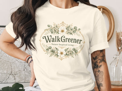 Cream t-shirt with oval floral graphic and text "Walk Greener Nature Inspired Living".