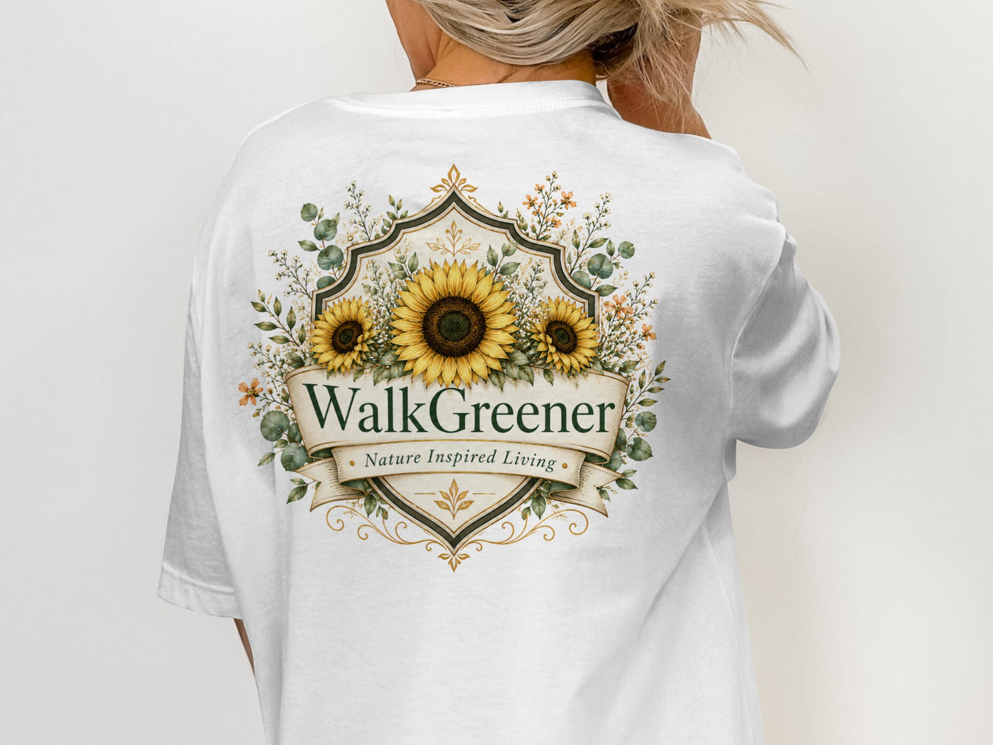 WalkGreener Nature Inspired Living logo with sunflowers and greenery on a white t-shirt.