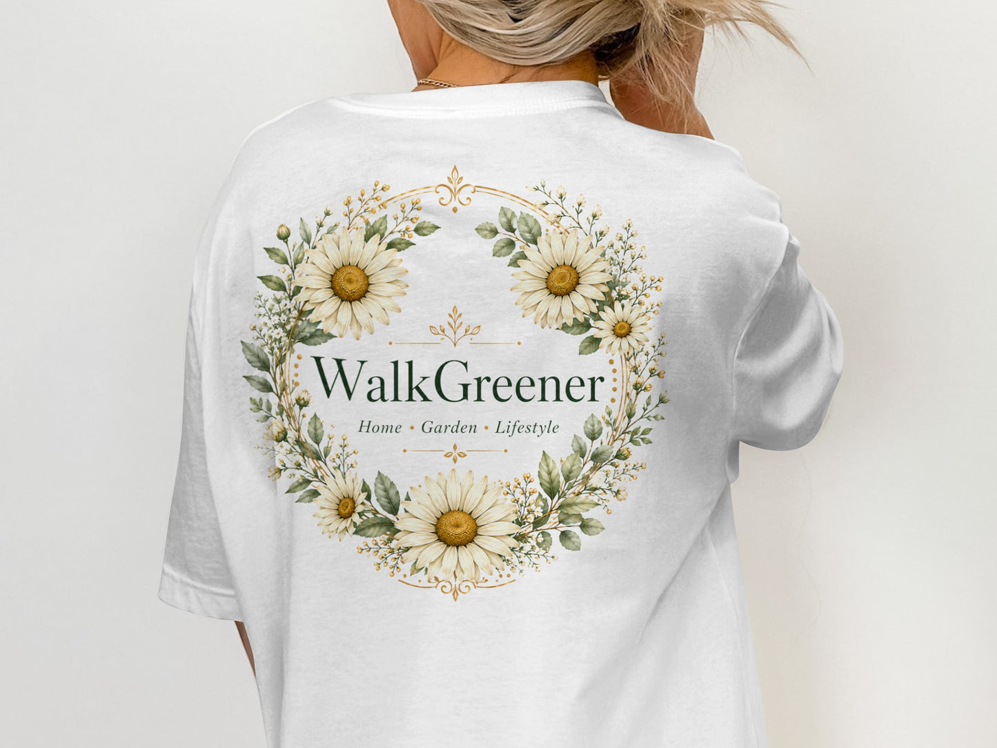 White t-shirt back with a floral wreath and "WalkGreener Home • Garden • Lifestyle" text.